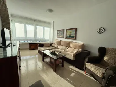 a living room with a couch and a table at Aires de Regla, Apartamentos Living Sur in Chipiona