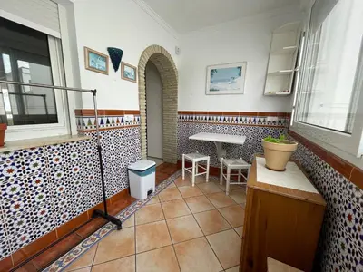 a room with a table and a table and chairs at Aires de Regla, Apartamentos Living Sur in Chipiona
