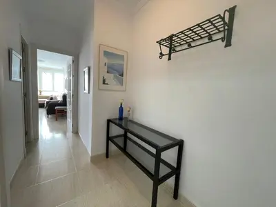 a room with a black shelf on a wall at Aires de Regla, Apartamentos Living Sur in Chipiona