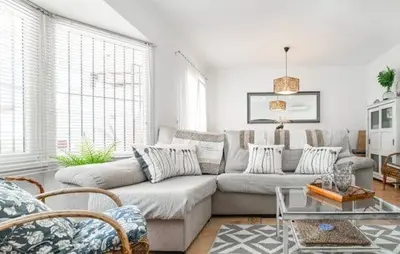 a living room with a couch and a table at Villa Lolera in Chiclana de la Frontera