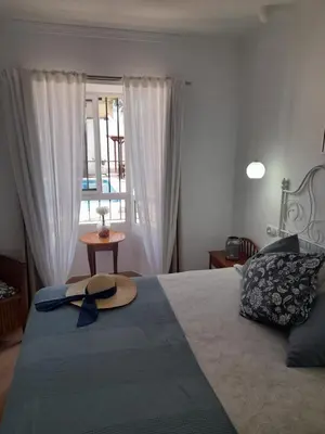 a hat on top of a bed in a bedroom at Villa Lolera in Chiclana de la Frontera