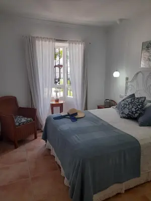 a bedroom with a bed with a hat on it at Villa Lolera in Chiclana de la Frontera