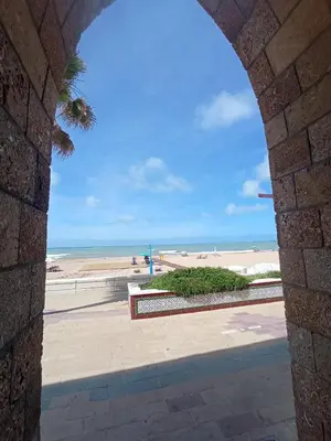 a view of the beach from a stone archway at Casa Reyes in Rota