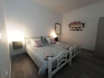 a bedroom with a white bed with pink pillows at Casa Reyes in Rota