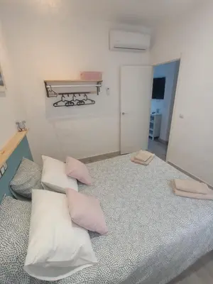 a room with a bed with four pillows on it at Casa Reyes in Rota