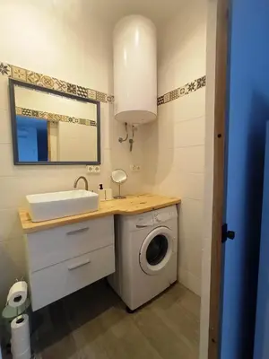 a bathroom with a washing machine and a sink at Casa Reyes in Rota