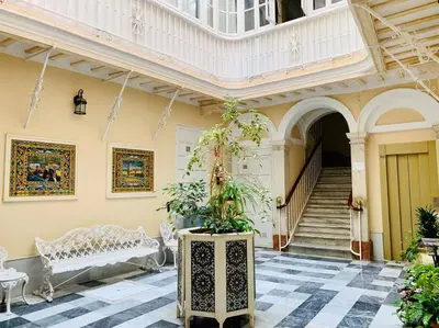 a building with a staircase and a room with a potted plant at La Primera de Occidente in Cádiz