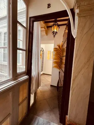 a kitchen with a table and a dining room at La Primera de Occidente in Cádiz