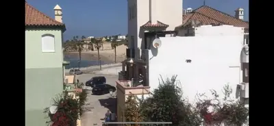 a view of a street with a white building at Apartamento terraza puerto sherry. in El Puerto de Santa María