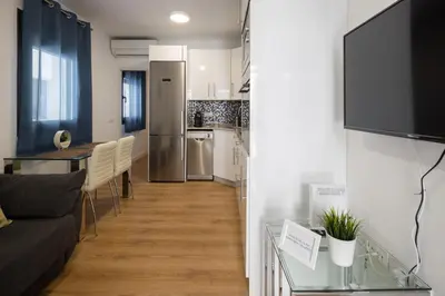 a living room with a couch and a table at El Sol & la Sal de Cádiz Little Apartments in Cádiz