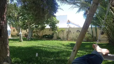 a persons feet on a swing in a yard at Villa Antonia in Chipiona