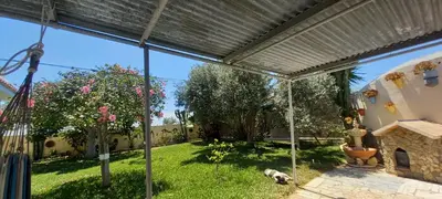 a view of a backyard with a dog laying on the grass at Villa Antonia in Chipiona