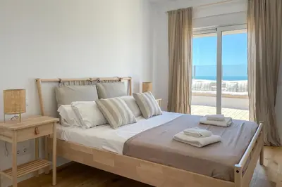a bedroom with a bed with a view of the ocean at INFINITY Sunny Home by Cadiz4Rentals in Cádiz