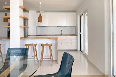 a kitchen with a glass table and stools at INFINITY Sunny Home by Cadiz4Rentals in Cádiz