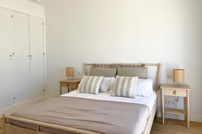 a bedroom with a bed with two night stands and two tables at INFINITY Sunny Home by Cadiz4Rentals in Cádiz