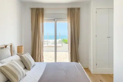 a bedroom with a bed with a view of the ocean at INFINITY Sunny Home by Cadiz4Rentals in Cádiz