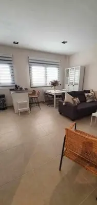 a living room with a couch and a table at Estupendo Piso Nuevo en Playa Victoria in Cádiz