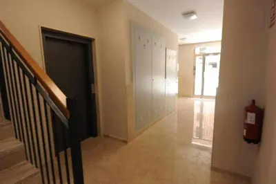 a hallway with a door and a fire extinguisher at Estupendo Piso Nuevo en Playa Victoria in Cádiz
