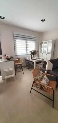 a living room with a couch and a table at Estupendo Piso Nuevo en Playa Victoria in Cádiz