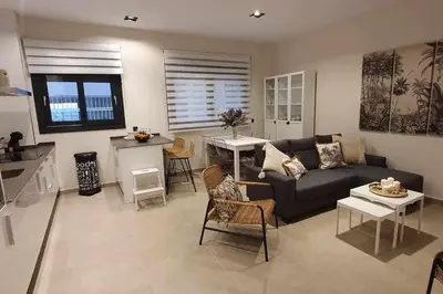 a living room with a couch and a table at Estupendo Piso Nuevo en Playa Victoria in Cádiz