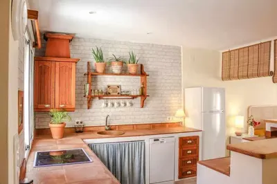 a kitchen with a sink and a refrigerator at MonKeys Apartments Sanlúcar Beach Relax in Sanlúcar de Barrameda