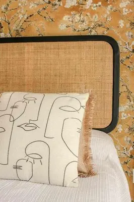a bed with a black and white comforter and a pillow at MonKeys Apartments Sanlúcar Beach Relax in Sanlúcar de Barrameda
