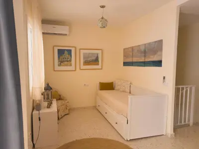 a small room with a bed and a couch at MonKeys Apartments Sanlúcar Beach Relax in Sanlúcar de Barrameda