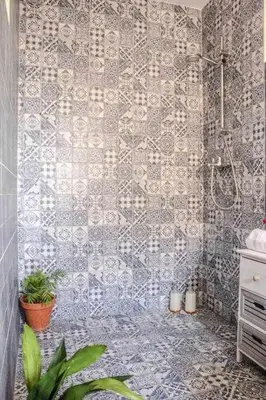a bathroom with a shower with a tiled wall at MonKeys Apartments Sanlúcar Beach Relax in Sanlúcar de Barrameda