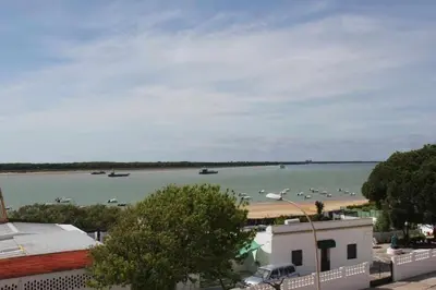 a view of a large body of water with boats in it at MonKeys Apartments Sanlúcar Beach Relax in Sanlúcar de Barrameda