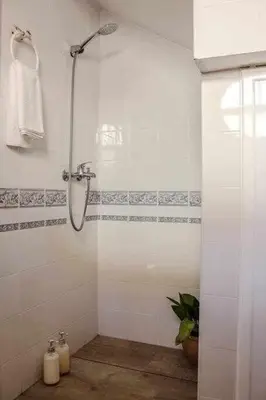 a bathroom with a shower with a glass door at MonKeys Apartments Sanlúcar Beach Relax in Sanlúcar de Barrameda