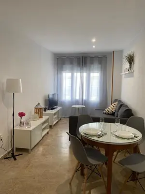 a living room with a table and a couch at Apartamento Tía Maria in Cádiz
