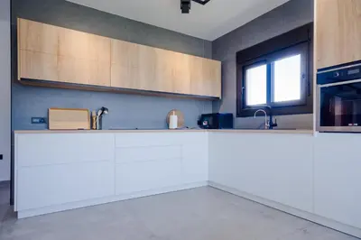 a kitchen with white countertops and a window at Villa Minerva in Chiclana de la Frontera