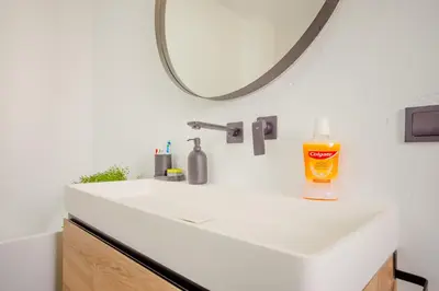a bathroom with a white sink and a mirror at Villa Minerva in Chiclana de la Frontera