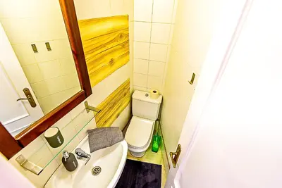 a small bathroom with a sink and a toilet at Plaza de Cárcel 3-bedroom Apartment in El Puerto de Santa María
