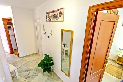 a hallway with a mirror on the wall at Plaza de Cárcel 3-bedroom Apartment in El Puerto de Santa María