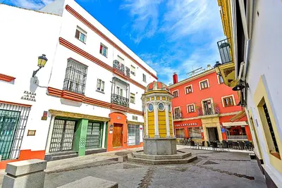 a tower in the middle of a street with buildings at Plaza de Cárcel 3-bedroom Apartment in El Puerto de Santa María