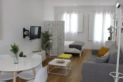 a living room with a couch and a table at Encanto de la Catedral Ha Loft in Cádiz