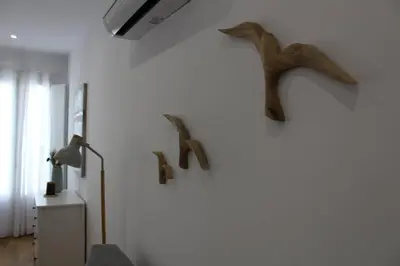 a room with a wall with two birds on the wall at Encanto de la Catedral Ha Loft in Cádiz