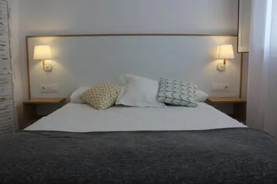 a bedroom with a bed with two pillows on it at Encanto de la Catedral Ha Loft in Cádiz
