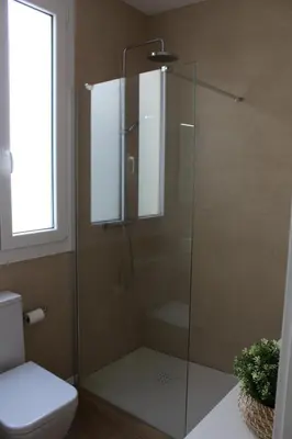 a glass shower in a bathroom with a toilet at Encanto de la Catedral Ha Loft in Cádiz