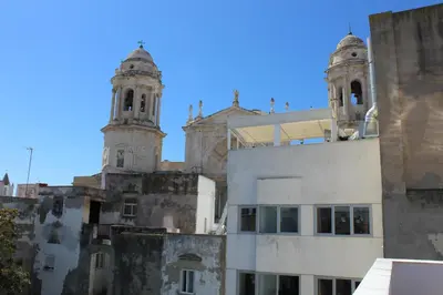 an old building with two towers on top of it at Encanto de la Catedral Ha Loft in Cádiz