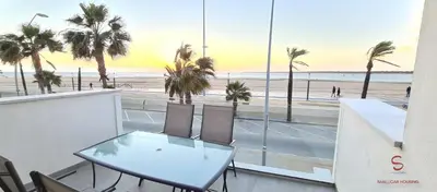 a table and chairs with a view of the beach at Arenas de Doñana by Sanlúcar Housing in Sanlúcar de Barrameda