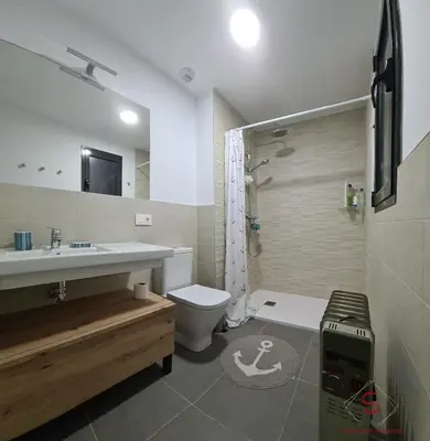 a bathroom with a sink and a toilet and a shower at Arenas de Doñana by Sanlúcar Housing in Sanlúcar de Barrameda