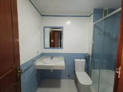 a bathroom with a sink and a toilet and a mirror at Apartamento Cream MRZ Rentals in Jerez de la Frontera