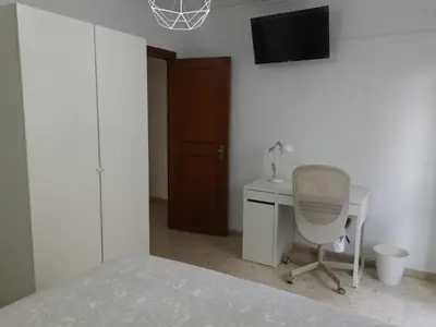 a bedroom with a bed and a desk and a chair at Apartamento Cream MRZ Rentals in Jerez de la Frontera