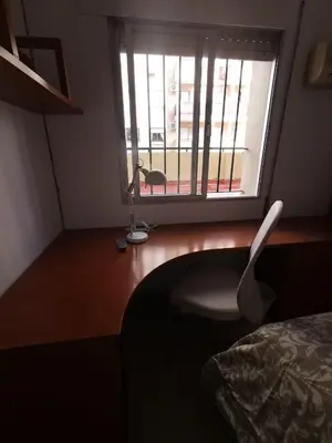 a bedroom with a desk with a chair and a window at Apartamento Cream MRZ Rentals in Jerez de la Frontera