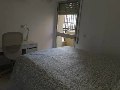 a bedroom with a bed and a desk and a chair at Apartamento Cream MRZ Rentals in Jerez de la Frontera
