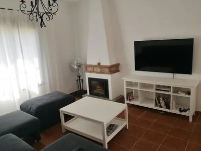 a living room with a tv and a fireplace at Casa Alma in Conil de la Frontera
