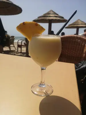a drink in a glass sitting on a table at Casa Alma in Conil de la Frontera