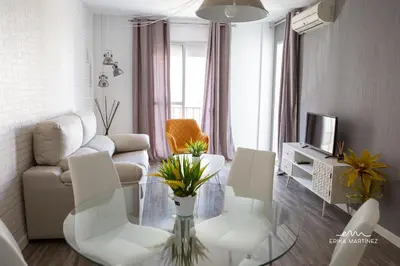a living room with white furniture and a glass table at JEREZ FERIA in Jerez de la Frontera